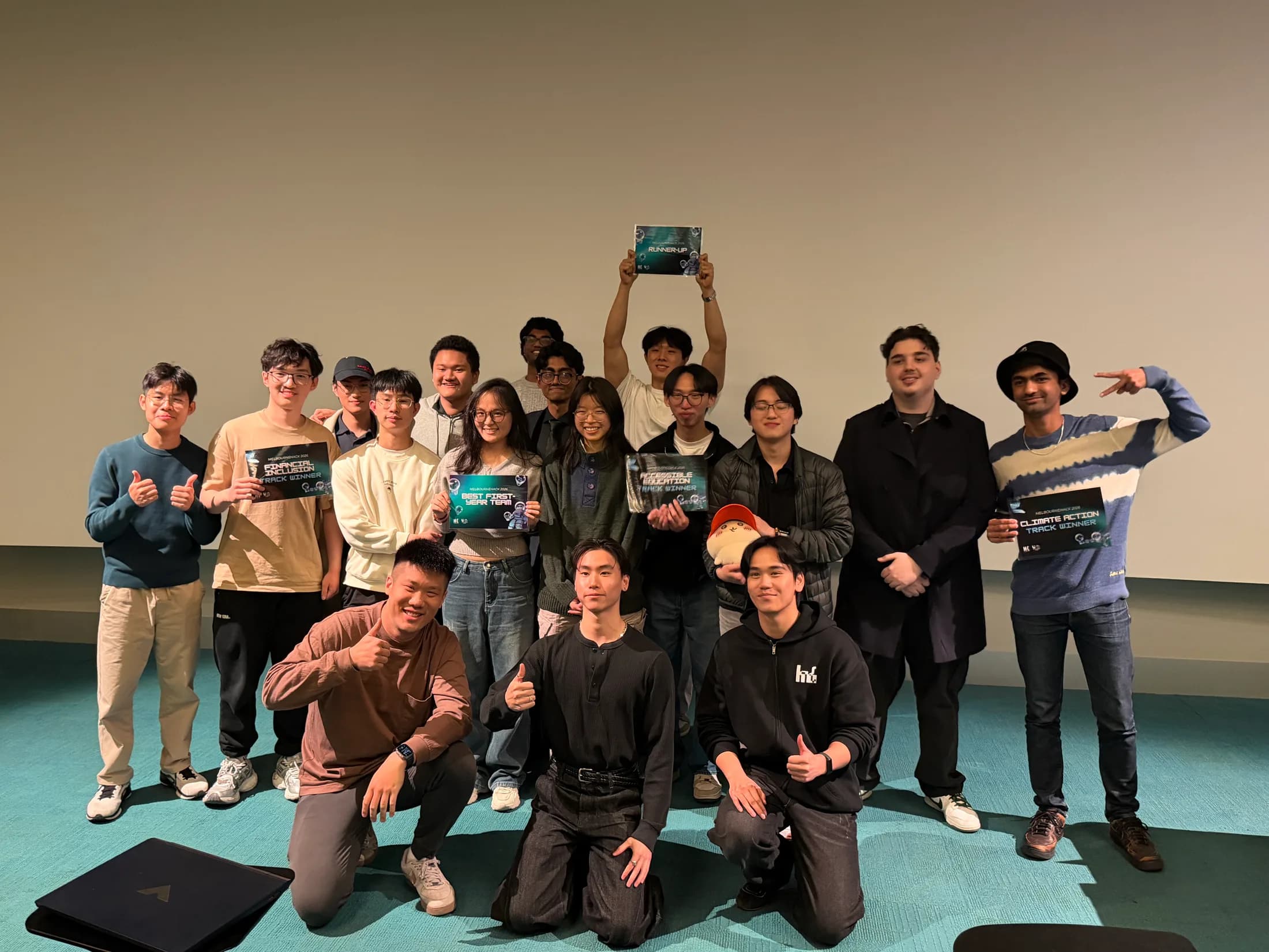 Melbourne Hack 2026 track winners holding their certificates